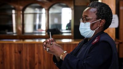 A health care worker prepares a dose of the Pfizer vaccine in Johannesburg, South Africa. Reuters