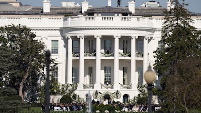 The bride walked down an aisle that led from the Diplomatic Reception Room to the altar of shrubs and white flowers. AP