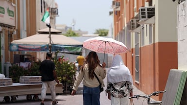 People shelter from the sun during the hottest part of the day in Satwa, Dubai. Chris Whiteoak / The National