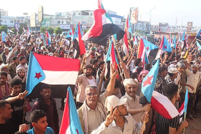 Supporters of the Southern Transitional Council, which wants to revive an independent state in southern Yemen, wave the old South Yemen flag at a rally in the port city of Aden on December 8, 2025. AFP