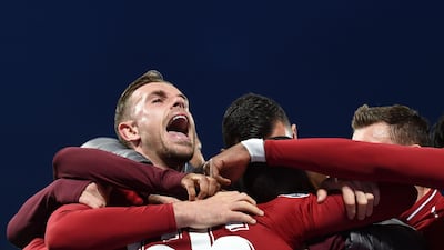 Jordan Henderson celebrates after Liverpool's Dutch midfielder Georginio Wijnaldum scores their third goal. AFP