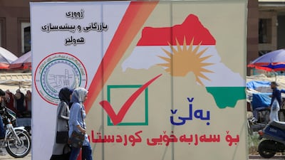Iraqi women walk on the street in Erbil near banners supporting the referendum for Kurdish independence. Alaa Al Marjani / Reuters