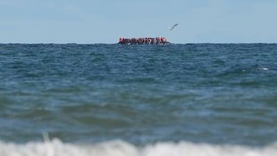 A group of migrants on board a small boat off the coast of Dunkirk, France, during an attempt to cross the Channel to the UK. PA