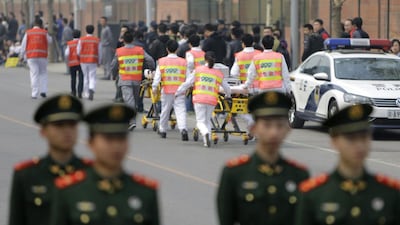 First-aid medical staff and paramilitary police are seen outside the Malaysia embassy as family members of passengers aboard Malaysian Airlines MH370 protest. Jason Lee / Reuters