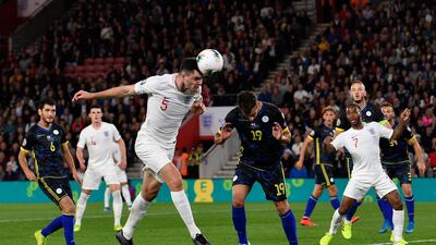 England's Michael Keane heads the ball. EPA