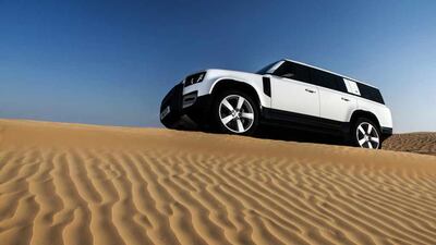 A Defender 130 taking on some of the UAE's most slippery dunes