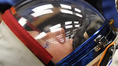 Nick Hague is helped by specialists as his space suit is tested. AFP