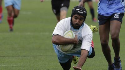 A UAE Shaheen player dives for the tryline against Dubai Sharks XV on Friday in a UAE Community League match. Jeffrey E Biteng / The National / April 1, 2016