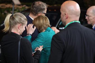 German Chancellor Angela Merkel rests her head on the shoulder of Finnish Prime Minister Juha Sipila June 29, 2018 after all-night talks on the first day of the European Union summit in Brussels. Ludovic Marin / AFP