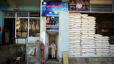 Jiu Jitsu club member opens the club's door club ahead of a training session in Kabul. AP