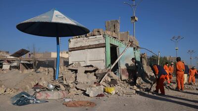 Afghan municipality workers inspect the scene of an explosion that targeted a police checkpoint in Herat, Afghanistan. EPA