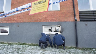 Police officers investigate a suspected arson attack after a fire in a mosque in the southern Swedish town of Eslov on December 29, 2014. Drago Prvulovic/AFP Photo
