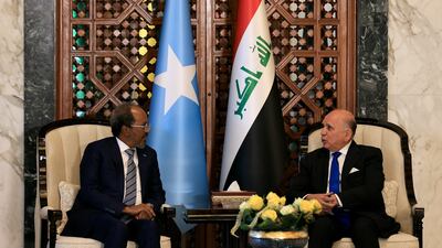 Somali President Hassan Sheikh Mohamud, left, is received by Mr Hussein. Reuters