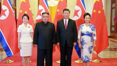 North Korean leader Kim Jong-un and his wife and his wife Ri Sol-ju, left, pose for a photo with Chinese President Xi Jinping and his wife Peng Liyuan at the Great Hall of the People in Beijing, China. KCNA / EPA