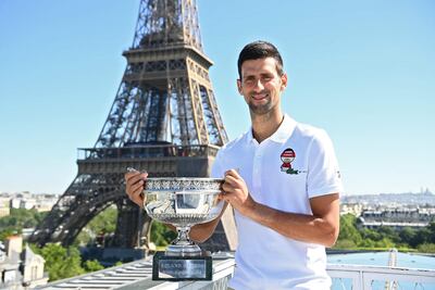 Serbia's Novak Djokovic poses with the trophy in front of the Eiffel tower. AFP