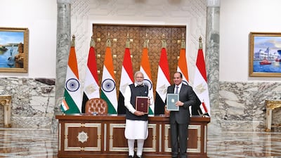 Mr El Sisi and Mr Modi pose for a photo after signing a memorandum of understanding. EPA