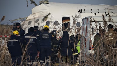 Emergency and security personnel are seen at the site of a plane crash near Almaty, Kazakhstan. Reuters