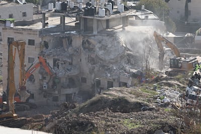 Israeli bulldozers demolish a Palestinian residential building in East Jerusalem. EPA