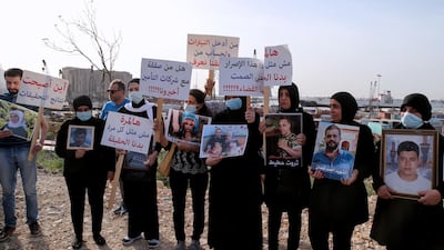 Protesters carry portraits of August 4 Beirut port blast victims during a demonstration in the Lebanese capital on May 4 2021. EPA