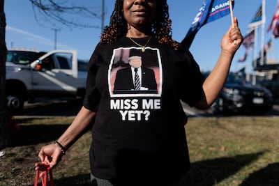 A supporter of Donald Trump attends a rally in support of the former US president in New York on Saturday. Mr Trump is to appear in court on Tuesday after a Manhattan grand jury indicted him last week. EPA