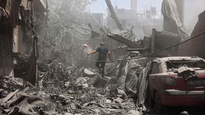 A Palestinian man inspects the rubble following Israeli strikes on the Al Qattaa family home in Al Tuffah neighbourhood in Gaza city on Saturday. AFP