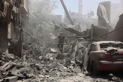 A Palestinian man walks through the rubble following Israeli strikes on the Al Qattaa family home in Al Tuffah district in Gaza city on May 31. AFP