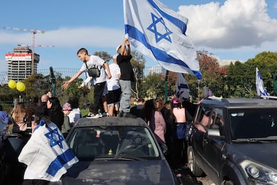 Israelis celebrate the hostage release in Petah Tikva on Saturday. Reuters