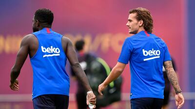Barcelona's French internationals Antoine Griezmann, right, and Samuel Umtiti head to training. AFP