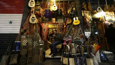 A Syrian man sits outisde a shop in the Old City of the capital Damascus. Louai Beshara / AFP Photo