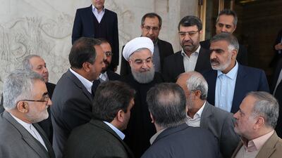 A handout photo made available by the presidential official website shows Iranian President Hassan Rouhani (C) greeting heads of parliament commissions after their meeting in Tehran, Iran, on January 1, 2018. EPA