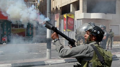 An Israeli border guard fires a tear gas canister during clashes with Palestinian youths over the flashpoint Al-Aqsa mosque compound, on September 21, 2015 at the main entrance of the West Bank city of Bethlehem. Musa Al Shaer/AFP Photo