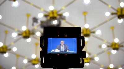 A television monitor shows Zhou Xiaochuan, governor of the People's Bank of China, as he announces that the country can hit this year's official growth target. Mark Schiefelbein / AP Photo