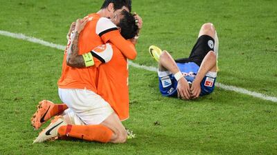 Dominik Stroh — Engel (L) and Benjamin Gorka (C) of Darmstadt celebrate while a Bielefeld player looks dejected after the Second Bundesliga Playoff Second Leg match between Armenia Bielefeld and Darmstadt 98 at Schueco Arena in Bielefeld, Germany. Thomas Starke / Getty Images