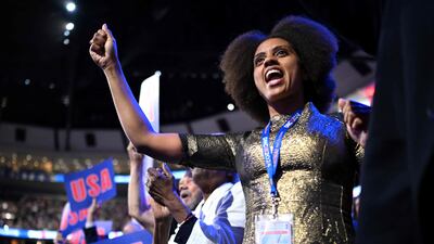 Delegates cheer during the DNC. AFP