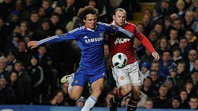Chelsea's David Luiz, left, and Manchester United's Wayney Rooney tussle for the ball at Stamford Bridge.