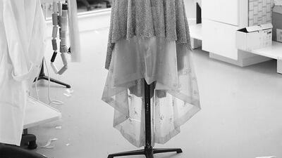 4. The dress is mounted on a wooden mannequin to check that the proportions and silhouette, as imagined by Lagerfeld, have been respected. As a finishing touch, the 14 jewelled buttons are sewn down the front of the dress. Courtesy Chanel