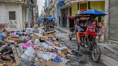 A 'cocotaxi' rider wears a T-shirt emblazoned with the US flag on a street in Havana, Cuba. AFP