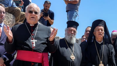 Melkite Greek Catholic Vicar Apostolic of Jerusalem Yasser Ayyash, right, and other clergy pray at Taybeh. AFP