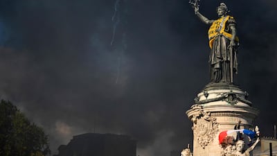 Heavy smoke around the statue in the Republic Square, in Paris. AFP
