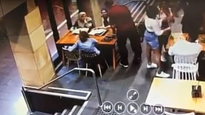 A screenshot from video footage of the attack on a pregnant Muslim woman in cafe in Sydney, Australia on November 20, 2019.