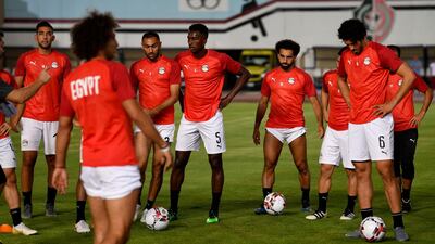 Players listen to the coaching staff during a training session. AFP