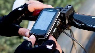 Victoria Norvall adjusts the settings on her Garmin Edge before she sets off on her morning bicycle ride around Nad Al Sheba. Victoria has been using the GPS device for about a month and is very happy with it. Razan Alzayani / The National