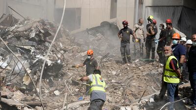 Rescuers clear the rubble as they look for survivors at the site of Friday's Israeli strike in Beirut's southern suburbs. AP