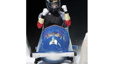 Germany's Andre Lange celebrates winning a gold medal at the finish of the final heat of the two-man bobsled event.