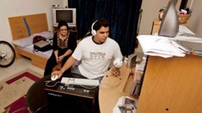 Mina Zuberi waits to go on-air as Muhammed Ali Jamadar ends his show on Campus Radio, an online project they produce in an apartment in Sharjah.