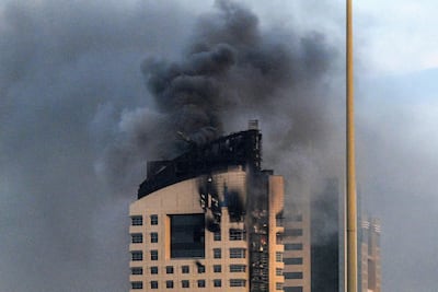 Smoke rises from a high-rise building following a drone attack in Kuwait City. AFP