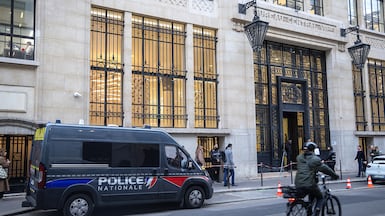 A French police van parked outside the Bank of America headquarters in Paris. EPA