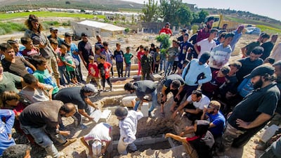 Mourners prepare a grave for a Syrian rebel killed by a Russian raid in the countryside of Aleppo, on September 26, 2021. AFP