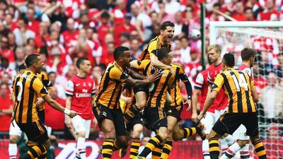 James Chester of Hull City celebrates with teammates after he scores their first goal against Arsenal in the FA Cup final on Saturday. Paul Gilham / Getty Images / May 17, 2014