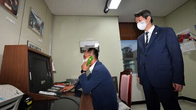 In this photo taken on September 16, 2020, South Korean Unification Minister Lee In-young looks at the inter-Korean hotline during a visit to the south side of the truce village of Panmunjom in the Demilitarised Zone dividing the two Koreas.